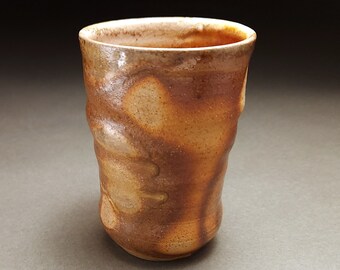 Drippy wood fired tumbler with orange glaze