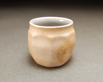 Faceted brown and gray wood fired shooter with pale blue glaze