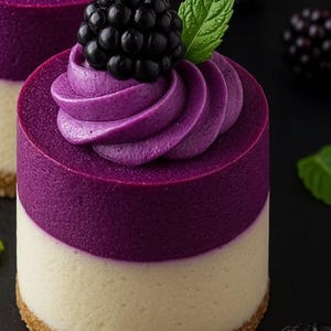 May include: A layered dessert with a graham cracker crust, a white cream layer, and a vibrant purple mousse. The dessert is topped with a swirl of purple cream and a fresh blackberry and mint leaf. The dessert is a treat.