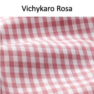 May include: Close-up of a fabric with a red and white gingham pattern. The fabric is slightly wrinkled, suggesting it is soft. The text "Vichykaro Rosa" is at the top of the image.