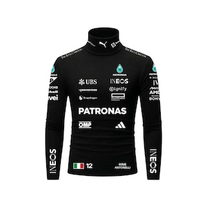 May include: A black long-sleeve mock neck shirt featuring various white sponsor logos including Petronas, Ineos, UBS, and CrowdStrike. The shirt displays the name Kimi Antonelli, the number 12, and an Italian flag graphic on the lower front section.