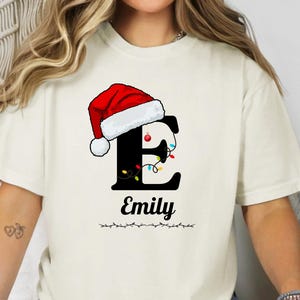 Custom Christmas Letter Shirt – Personalized Name Comfort Colors Tee, Cute Santa Hat Penguin Holiday Gift