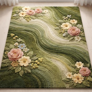 May include: Green floral area rug with a wavy design. The rug features raised floral accents in shades of pink, yellow, and white, with green leaves and accents. The rug's background has a textured, wavy pattern in varying shades of green.