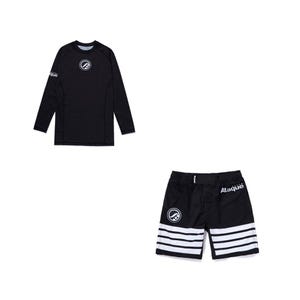 May include: A black long-sleeve rash guard shirt and matching black shorts. The shirt features a white circular logo on the chest and the text "Ataque" on the sleeve. The shorts have a white circular logo, the text "Ataque", and three white stripes.