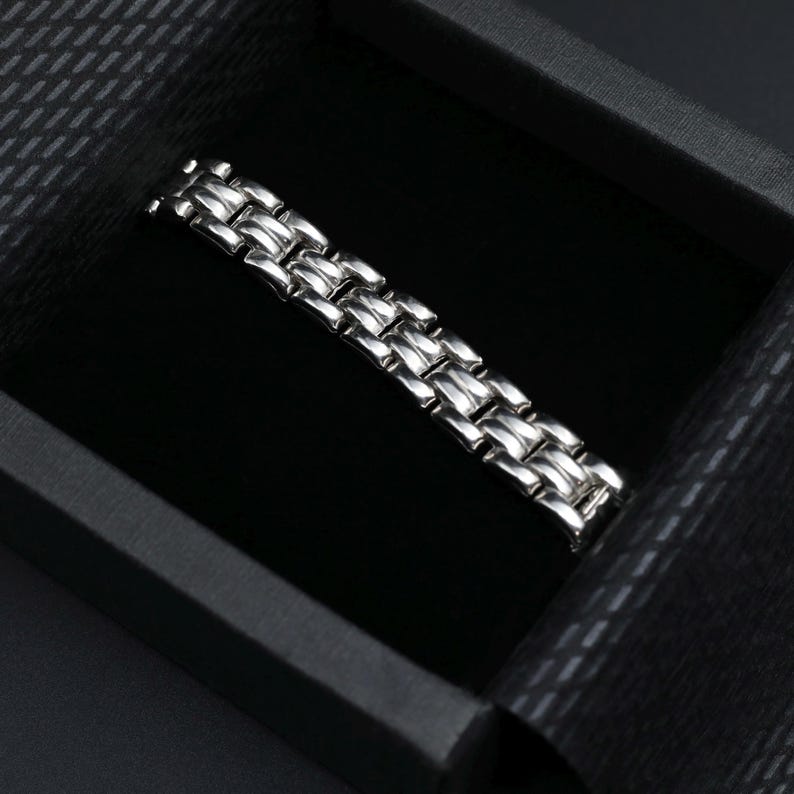A vintage sterling silver panther style link bracelet made in Italy is displayed on a dark background shown in the gift packaging your bracelet will arrive in