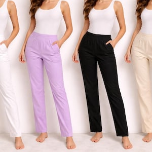 May include: Four pairs of straight-leg pants in white, lavender, black, and beige. Each pair has a relaxed fit with pockets. The models are wearing white tank tops.