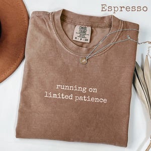 May include: A set of three ceramic mugs with a speckled, matte finish. The mugs are in cream, light grey, and dark grey. Each mug has a simple, minimalist design, ideal for coffee or tea.