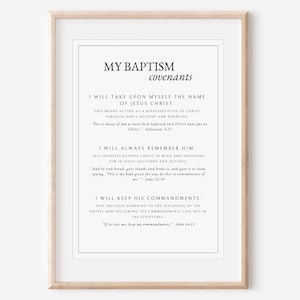 May include: Framed print with the text "MY BAPTISM covenants" in a minimalist design. The text includes biblical verses about baptism and keeping commandments. The frame is a light wood color, and the print is in black and white.