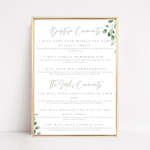 May include: A framed print with the text "Baptism Covenants" and "The Lord's Covenants" in elegant script. The text details promises and commitments. Greenery accents the corners. The frame is gold.