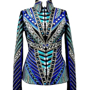 May include: A long-sleeved jacket with a high collar, featuring a striking geometric pattern in shades of blue, teal, and silver. The jacket is heavily embellished with what appears to be sequins or beads, creating a shimmering effect. The design is symmetrical and eye-catching.