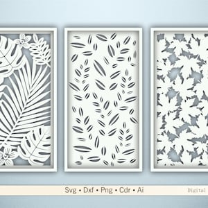 Könnte beinhalten: Drei weiß gerahmte Wandkunst-Paneele mit lasergeschnittenen botanischen Designs. Die Paneele zeigen tropische Blätter, Blättermuster und Ahornblätter. Der untere Teil des Bildes enthält den Text "Svg • Dxf • Png • Cdr • Ai Digital files."