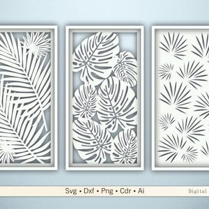 以下が含まれることがあります： 切り抜かれた葉のデザインが施された、白いフレームの壁掛けアート3点。デザインには、ヤシの葉、モンステラの葉、扇形の葉が含まれています。画像の下部には「Svg • Dxf • Png • Cdr • Ai」と「Digital files」の文字があります。