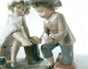 Lladro Figurine 5361, Boy Helping Girl With Shoes, Spanish