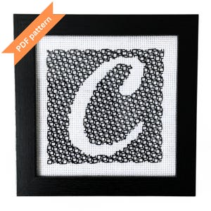 May include: Black framed cross-stitch art featuring the letter "C" in white against a black and white geometric pattern. The upper left corner has an orange banner that says "PDF pattern".