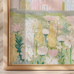 May include: A framed floral painting featuring a garden scene with white, yellow, and pink flowers. The artwork has a textured, impressionistic style, with a building in the background. The frame is gold-colored.