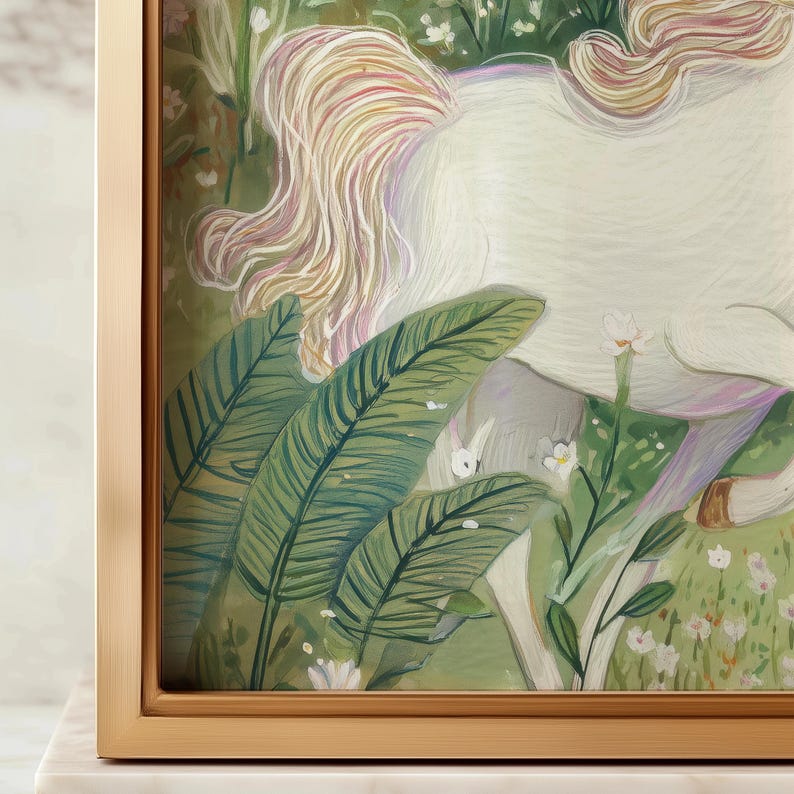 May include: A framed artwork featuring a white unicorn in a lush, green meadow. The unicorn's flowing mane is a mix of blonde and pink hues. Large green leaves and small white flowers add to the whimsical scene. The frame is a light gold color.