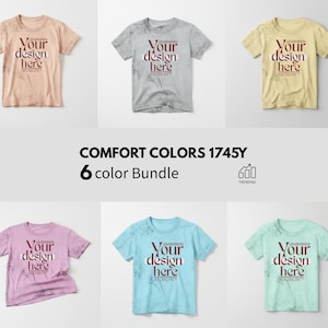 Puede incluir: Una colección de seis camisetas en varios colores: melocotón, gris, amarillo, rosa, azul claro y verde menta. Cada camiseta presenta el texto "Your design here" en un marco rectangular. También se muestra la frase "COMFORT COLORS 1745Y 6 color Bundle".