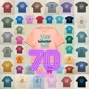 May include: A collection of 70 colorful t-shirts, each displaying the text "Your design here." The shirts vary in shades, including red, blue, green, and yellow. A large pink shirt in the center features the same text, with the number "70" and the word "Colors" in a neon outline.