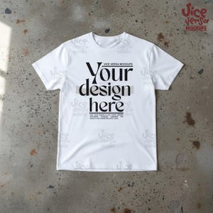 May include: White t-shirt with the text "Your design here" in a bold, black font. The shirt is a crew neck style and is displayed on a textured, gray surface. The image includes the text "Vice Versa Mockups".