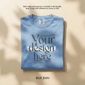 May include: A folded blue jean t-shirt with the text "Your design here" in a stylized font. The shirt also has the text "VICE VERSA MOCKUPS" and "BLUE JEAN". The shirt is on a light brown surface.