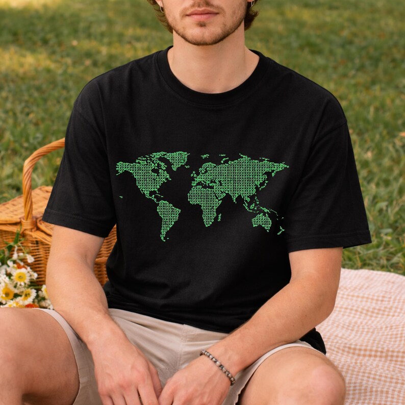 May include: Black t-shirt featuring a green world map design composed of binary code. The graphic covers the front of the shirt, showcasing continents and landmasses. The shirt is a casual, short-sleeved style.
