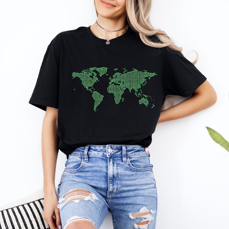 May include: Black t-shirt featuring a green binary code world map design. The graphic is a detailed representation of the continents and oceans. The shirt is made of a soft material and is suitable for casual wear.