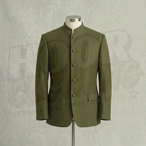 May include: An olive green jacket with a mandarin collar, four buttons, and two front pockets. The jacket is displayed on a mannequin. The style is a classic, tailored design.