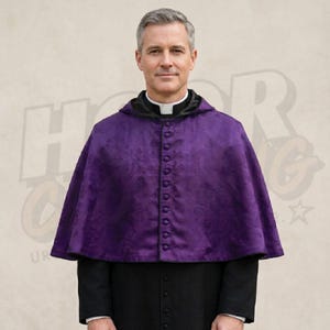 May include: A purple cape with a floral pattern and a row of buttons down the front. The cape has a black hood and is worn over a black garment. The person is wearing a white clerical collar.