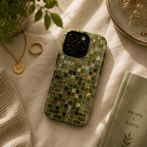 Peut inclure: Une coque de smartphone avec un motif en mosaïque composé de petits carreaux carrés dans des tons de vert, olive et doré. La coque présente une découpe noire pour l'appareil photo et recouvre le dos de l'appareil avec une finition brillante.
