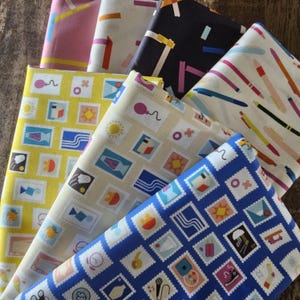 May include: A collection of colorful fabric swatches with various patterns. Designs include postage stamp motifs, abstract shapes, and pen illustrations. The color palette features yellow, blue, pink, and cream hues, creating a vibrant and artistic display.