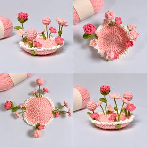 Könnte beinhalten: Eine kleine, runde, gehäkelte Schale in Rosa mit weißem, gewelltem Rand, verziert mit verschiedenen gehäkelten rosa und roten Blumen sowie grünen Stielen am Rand. Ein Knäuel rosa Garn ist in der Ecke des Bildes zu sehen.