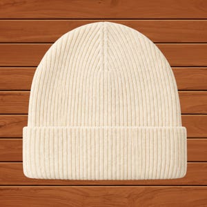 May include: Cream-colored ribbed knit beanie hat. The hat features a folded brim and a close-fitting design. The hat is made of a soft, warm material, perfect for cold weather. This winter hat is a versatile accessory.
