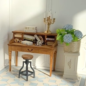 May include: A miniature wooden desk with a drawer, filled with books and papers, sits beside a small stool. A gold candelabra and a potted hydrangea plant on a pedestal add decorative touches to the scene. The floor has a blue and white pattern.