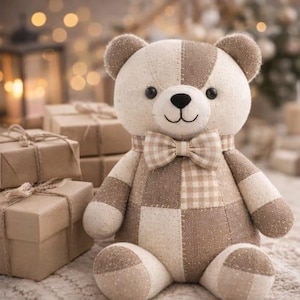 May include: A handmade teddy bear with a patchwork design in cream and brown tones. The bear has a checkered bow tie and black button eyes. Several wrapped gift boxes are in the background.