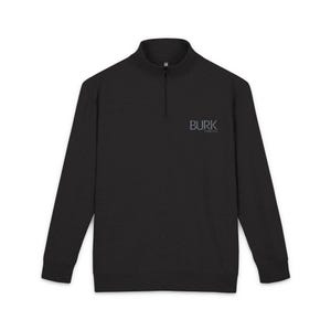 May include: Black long-sleeve pullover with a quarter-zip neckline. The shirt features the text "BURK" in a light blue font on the upper left chest. The garment has a ribbed hem and cuffs.