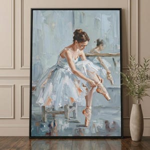 May include: Oil painting of a ballerina in a white tutu, seated and tying her pointe shoes. The artwork features a soft color palette of blues, whites, and peach tones, with visible brushstrokes. A mirror reflects the ballerina's form.
