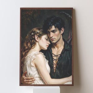 May include: A framed wall art print depicting a fantasy illustration of two figures embracing. One figure has long wavy hair with a floral accessory and pointed ears, wearing a white dress. The other figure has dark hair and wears a black lace-up shirt.