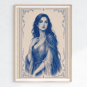 May include: A framed blue and white portrait of a woman with long, dark hair. The artwork features a detailed illustration of a woman in a flowing gown, with a decorative border. The portrait is set against a beige background.