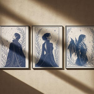 May include: Three framed art prints featuring celestial-themed illustrations in navy blue. Each print showcases a figure in profile, surrounded by botanical elements and stars. The artwork has a vintage aesthetic.