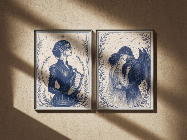May include: Two framed art prints. The left print features a woman in a dark blue dress holding a harp. The right print depicts a couple embracing, with the man having dark wings. Both prints have a blue and cream color scheme.