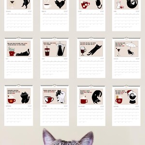 May include: A 2027 wall calendar featuring twelve monthly pages, each displaying a black cat illustration paired with coffee-themed imagery and text. The calendar pages are arranged in a grid, and a tabby cat head is visible at the bottom.