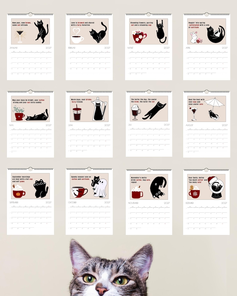 May include: A 2027 wall calendar featuring twelve monthly pages, each displaying a black cat illustration paired with coffee-themed imagery and text. The calendar pages are arranged in a grid, and a tabby cat head is visible at the bottom.