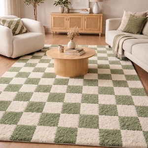 May include: A green and white checkered rug in a living room setting. The rug is the focal point, with a repeating pattern of green and white squares. The room also features a light-colored sofa, chairs, and wooden furniture.