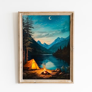 May include: Framed art print of a camping scene at night. A lit tent and campfire sit near a lake, with mountains in the background under a starry sky and crescent moon. The artwork is in a rustic wooden frame.