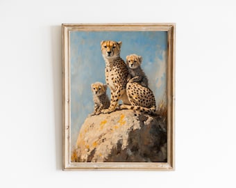 May include: Framed vintage painting of a cheetah family. The mother cheetah sits atop a rock with two cubs. The cheetahs have tan fur with black spots. The background is a blue sky with clouds. The frame is a light brown color.