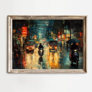 May include: A framed painting depicts a rainy city street at night. The artwork features vibrant colors, with reflections of lights on the wet pavement. Motorbikes and vehicles are visible, creating a dynamic urban scene.