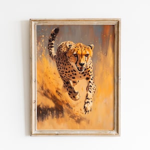 Puede incluir: Obra de arte enmarcada que representa un guepardo en plena carrera. El guepardo tiene un pelaje marrón con manchas negras, sobre un fondo cálido naranja y marrón. El marco es de color claro y neutro.