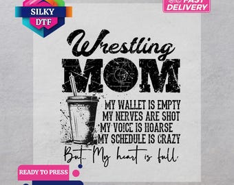 May include: White DTF transfer with the text "Wrestling MOM" and a graphic of a coffee cup. The text below reads "My wallet is empty, my nerves are shot, my voice is hoarse, my schedule is crazy, but my heart is full."