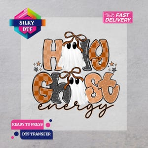 May include: A DTF transfer design featuring the text Holy Ghost energy in a mix of orange checkered and dark gray star-patterned block letters. Two white ghosts with brown bows are positioned between the letters, accented by small stars.