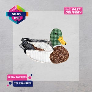 May include: A fabric duck transfer with a green checkered head, brown floral chest, and various patterned wings. The image includes the text "SILKY DTF", "READY TO PRESS", "DTF TRANSFER", and "FAST DELIVERY".